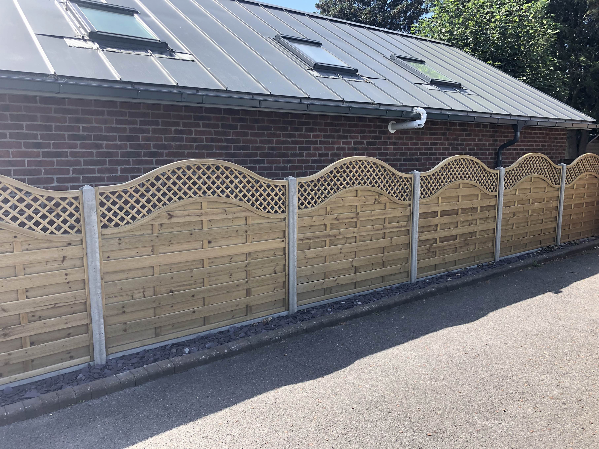 Wooden panel garden fence with trellis top by North Oaks Fencing in Hampshire